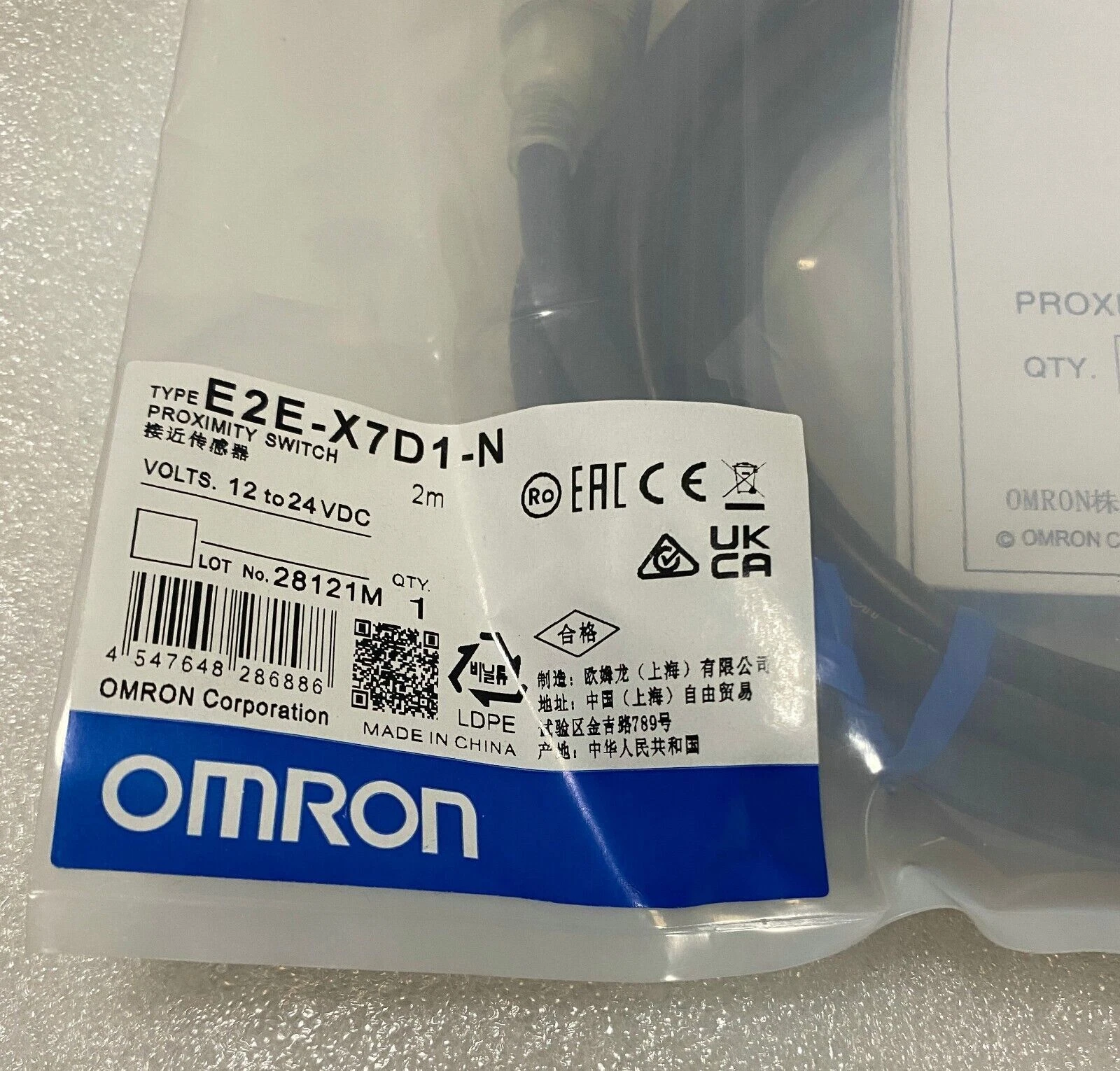 E2E-X7D1-N external product-reference label close-up showing 2 m and 12 to 24 VDC markings; not J&V stock or authenticity proof